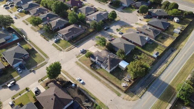 Dark solar panel installations cover composite shingle rooftops along Nicole Court cul de-sac. Paved four way intersections meet tidy front lawns, parked motor vehicles, Arlington, Texas