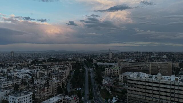 Drone view of a city landscape in Aleppo, Syria. Urban skyline and residential neighborhoods from above. City streets, infrastructure, and middle eastern architecture.
