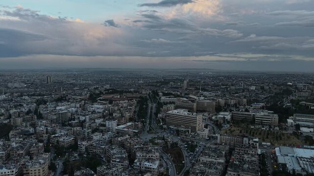 Drone view of a city landscape in Aleppo, Syria. Urban skyline and residential neighborhoods from above. City streets, infrastructure, and middle eastern architecture.