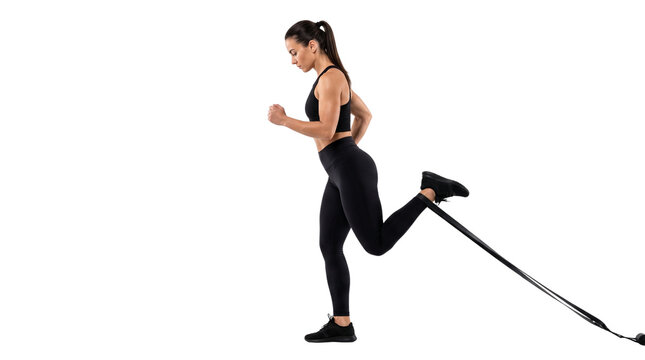 Athletic woman performing resistance band leg curls, fit female athlete in black sportswear training glutes and hamstrings isolated PNG with Transparent Background