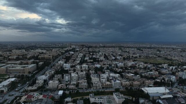 Drone view of a city landscape in Aleppo, Syria. Urban skyline and residential neighborhoods from above. City streets, infrastructure, and middle eastern architecture.