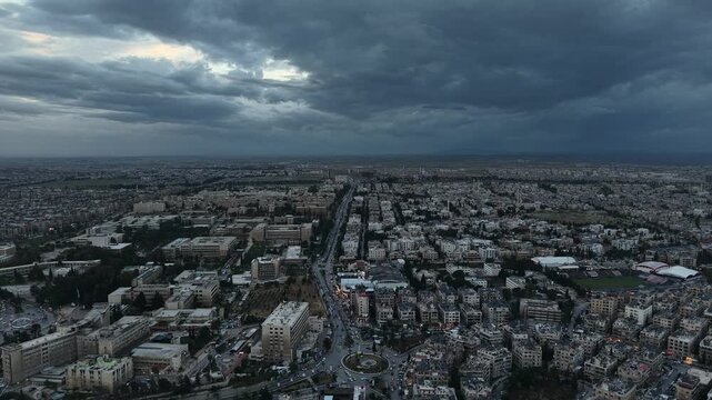 Drone view of a city landscape in Aleppo, Syria. Urban skyline and residential neighborhoods from above. City streets, infrastructure, and middle eastern architecture.