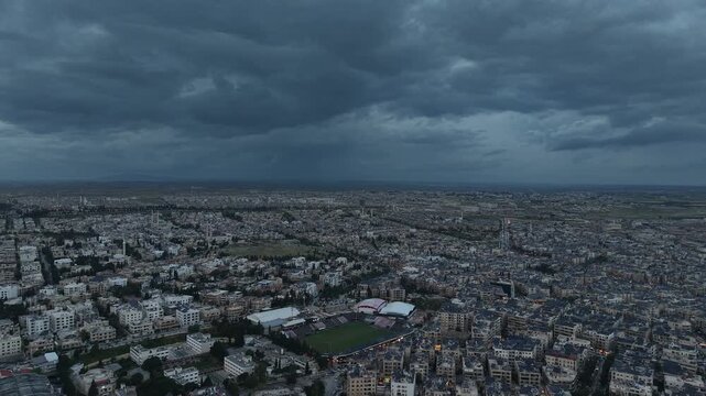 Drone view of a city landscape in Aleppo, Syria. Urban skyline and residential neighborhoods from above. City streets, infrastructure, and middle eastern architecture.