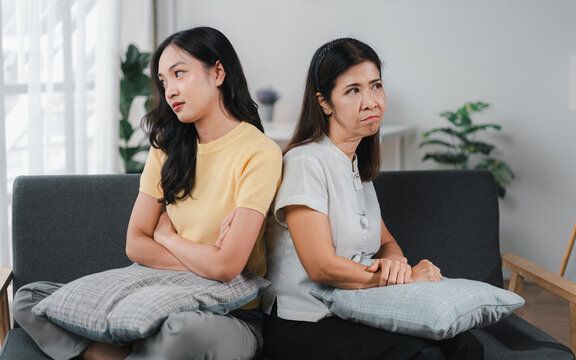 Family Conflict Asian Women Mother Daughter Back to Back on Sofa