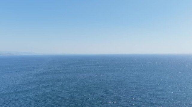 Wide, clear daytime view over the Atlantic Ocean from the coast near Faro de Fisterra lighthouse in Finisterre, Galicia, Spain.