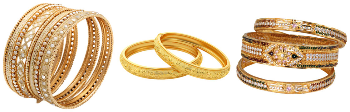 A collection of ornate gold bangles, some with intricate patterns and embedded stones, isolated on a white background.