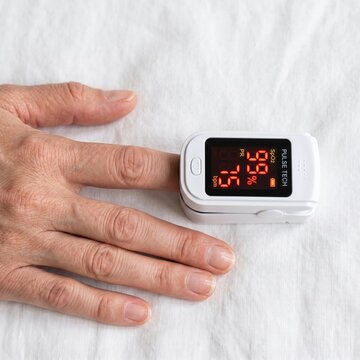 Pulse oximeter monitoring oxygen saturation provides crucial data for personal health management, reflecting an investment in human capital.