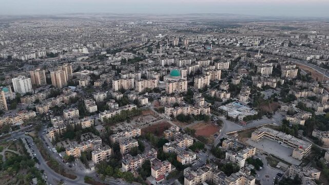 Drone view of a city landscape in Aleppo, Syria. Urban skyline and residential neighborhoods from above. City streets, infrastructure, and middle eastern architecture.