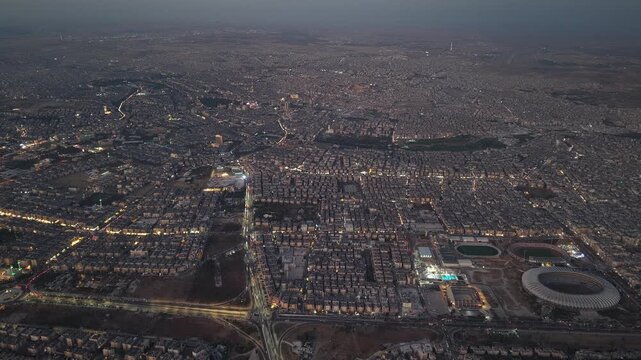 Drone view of a city landscape in Aleppo, Syria. Urban skyline and residential neighborhoods from above. City streets, infrastructure, and middle eastern architecture.