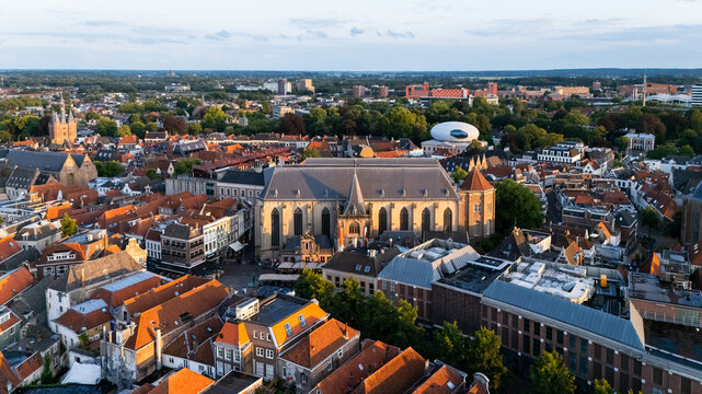 Aerial view of the historic city center of Zwolle featuring the Grote Kerk, traditional orange rooftops, and modern buildings in Zwolle, Overijssel, Netherlands.