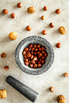 close up of ingredients for making spices and herbs in mortar stone background top view