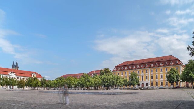 Cathedral Square, Magdeburg, Saxony-Anhalt, Germany; the State Parliament on the left side, the Ministry of Justice and Consumer Protection opposite, time-lapse with motion blur of people