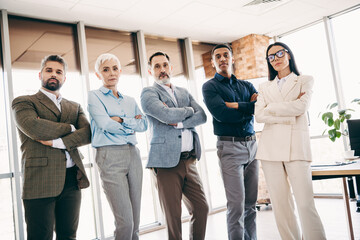 Fototapeta premium Professional business team standing together in modern office, showcasing teamwork, confidence, and corporate success
