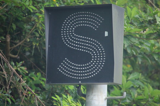 Railway LED signal light showing letter S