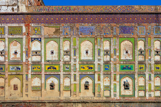 View of the intricate tile work and colorful frescoes on the historic Pictured Wall of the Lahore Fort in Lahore, Punjab, Pakistan.