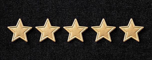 Fototapeta premium Gold star decorations aligned horizontally on rich velvet, ideal for upscale holiday cards and event invites.