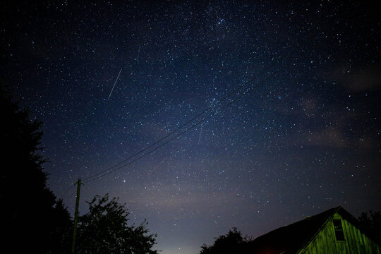 night sky with falling stars in the village