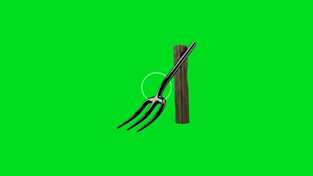 A shiny black metal garden pitchfork rests against a vertical wooden post