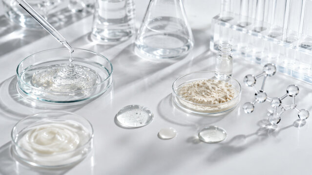 Laboratory cosmetic formulation with pipette, petri dishes and molecular model for skincare research and product development