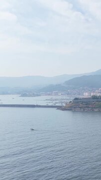 Vertical 9:16 video showing a tranquil coastal scene from Castelo de Monterreal in Baiona, Spain.