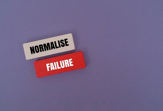 Colorful blocks with text "NORMALISE FAILURE". Growth mindset, mental health awareness and resilience in business and life concepts