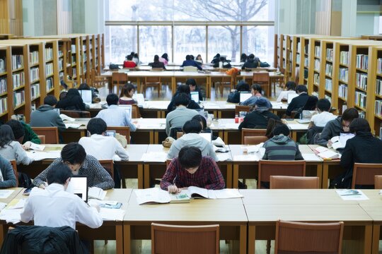 Japanese University Students Reading Books in Library