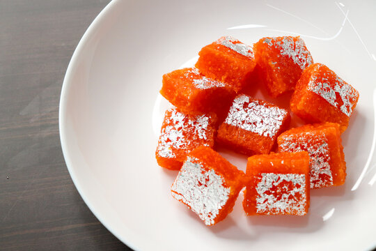 Nagpur Orange Barfi. Traditional Indian mithai made with milk solids and fresh Nagpur orange pulp. Soft, creamy fudge texture with tangy citrus flavor, inspired by India&rsquo;s Orange City.
