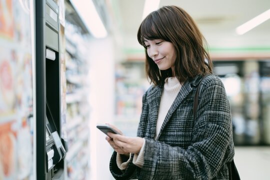 Young Woman Making Contactless Payment in Japan