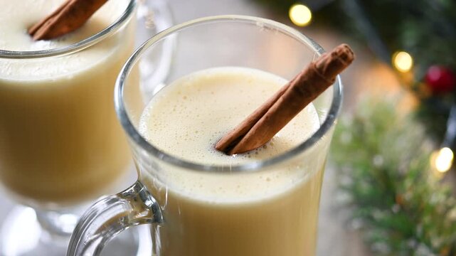 Eggnog with Cinnamon in glass on wooden table