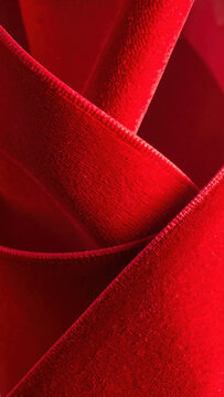 Red velvet fabric texture abstract background with folded textile layers creating rich depth and dramatic luxury mood Christmas Concept