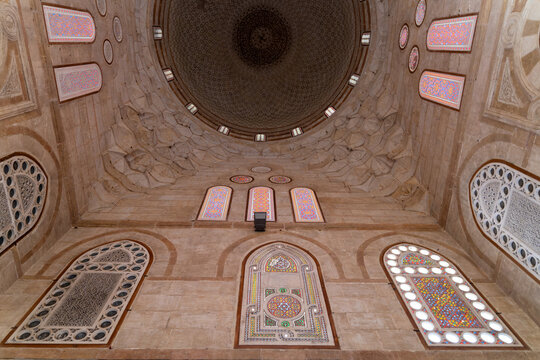 View of the intricate stone dome and colorful stained glass windows inside the historic Amir Khayrbak Funerary Complex in El-Darb El-Ahmar, Cairo Governorate, Egypt.