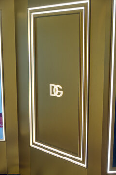 Illuminated DG Logo Dolce Gabbana on a Modern Gold Wall with Glowing Frame Accents, Representing Luxury Branding - Moscow, Russia, August 11, 2026