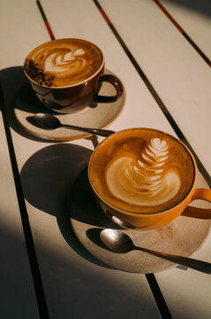 Two cappucino coffees with latte art