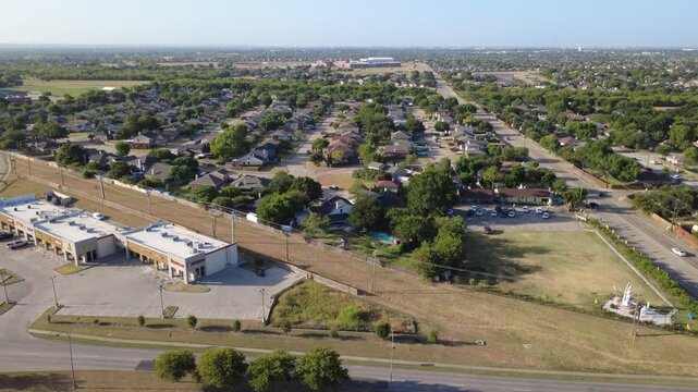 Spacious commercial parking plazas face East Sublett Road retail corridor. Low rise business centers border expansive grassy corner lots, quiet suburban subdivisions, Arlington, Texas
