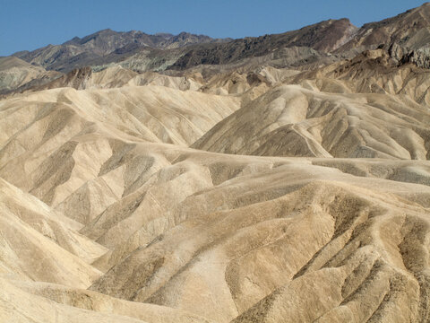 View of the eroded badlands and golden ridges of Zabriskie Point in Death Valley, California, United States.