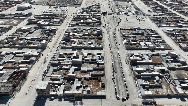 Aerial view of the town of Uyuni featuring a grid street layout, low-rise buildings, and parked vehicles in Uyuni, Potosi Department, Bolivia.
