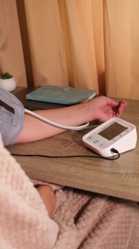 Monitoring blood pressure at home using a digital device in a cozy indoor setting