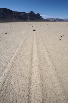 View of Racetrack Playa with its iconic sliding rocks and cracked mud surface in Death Valley, California, United States.