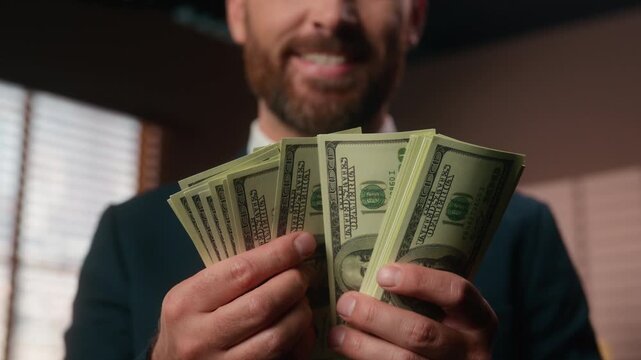 Unrecognizable smiling Caucasian business man count cash smile happy rejoice success currency exchange male hands holding dollars stack counting money cheerful businessman employer with salary savings