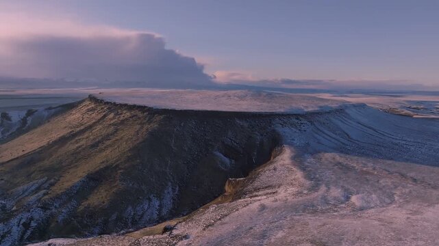 Aerial view of the rugged snow-dusted plateaus of the Morley Nelson Snake River Birds of Prey National Conservation Area at sunset in Murphy, Idaho, United States.