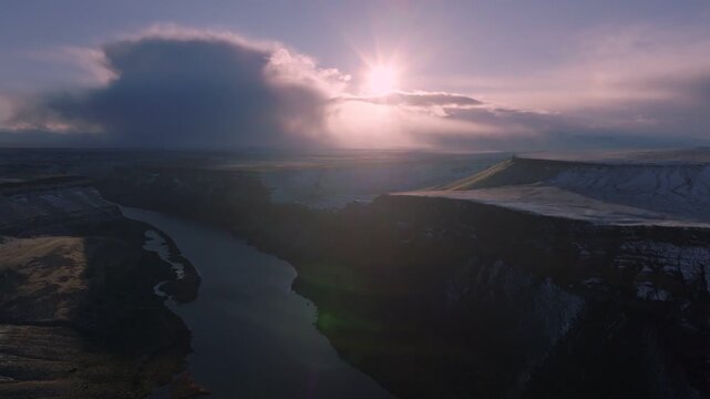 Aerial view of the Snake River canyon at sunset with snow-dusted cliffs in the Morley Nelson Snake River Birds of Prey National Conservation Area, Murphy, Idaho, United States.