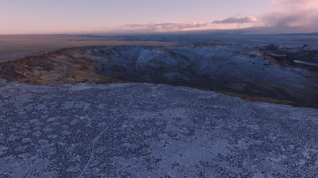 Aerial view of the snowy landscape of the Morley Nelson Snake River Birds of Prey National Conservation Area at sunset in Murphy, Idaho, United States.