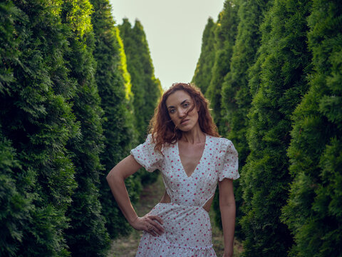 young woman in a white dress in the forest