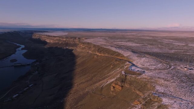 Aerial view of the Morley Nelson Snake River Birds of Prey National Conservation Area featuring rugged canyon cliffs and vast plains at sunset in Murphy, Idaho, United States.