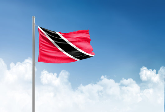 Trinidad and Tobago flag waving in beautiful sky.