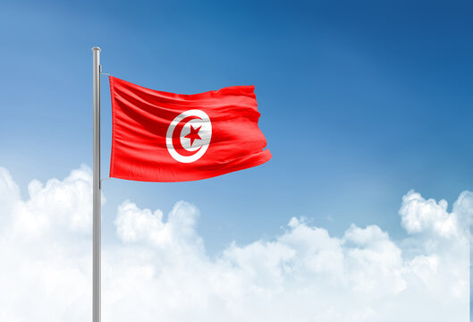 Tunisia flag waving in beautiful sky.