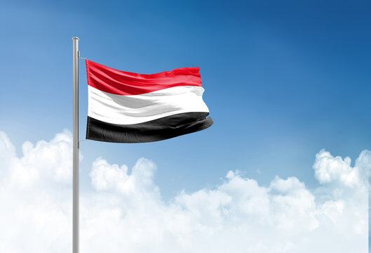 Yemen flag waving in beautiful sky.