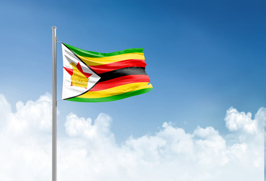 Zimbabwe flag waving in beautiful sky.