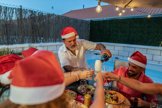 Family enjoying christmas dinner on outdoor patio