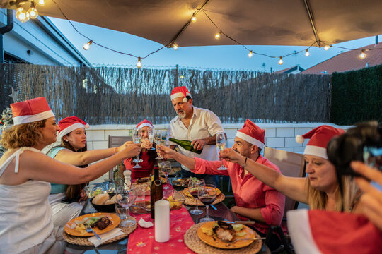 Family and friends celebrating christmas holiday season toasting